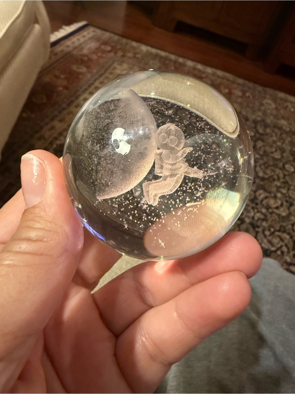 A 3D laser-engraved glass crystal sphere featuring an astronaut and moon design.
